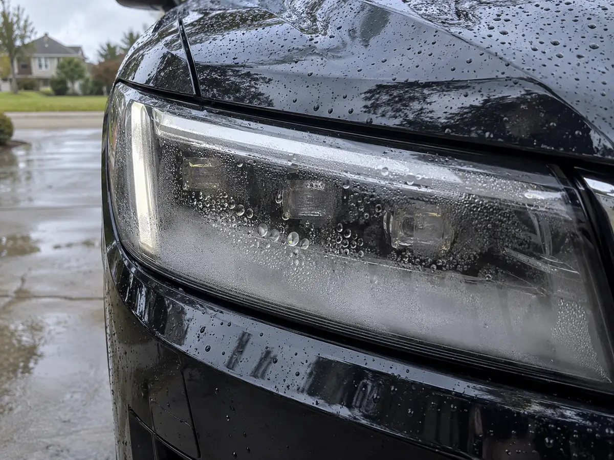 Water droplets on the inside of an Escalade headlight lens
