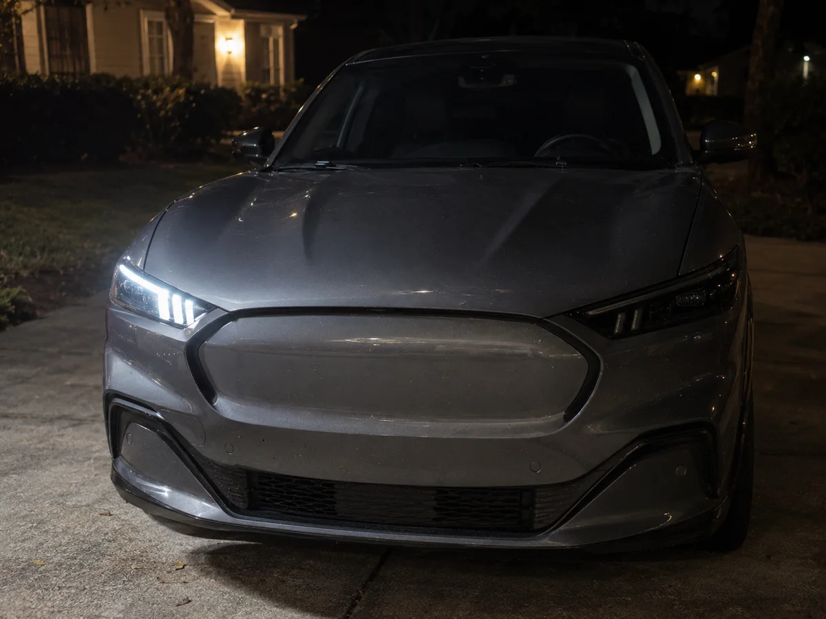 Front of a Ford electric SUV at night with the LED headlight dark on the driver side