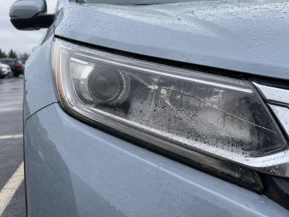 Honda CR-V headlight with a cracked lens and condensation inside the casing