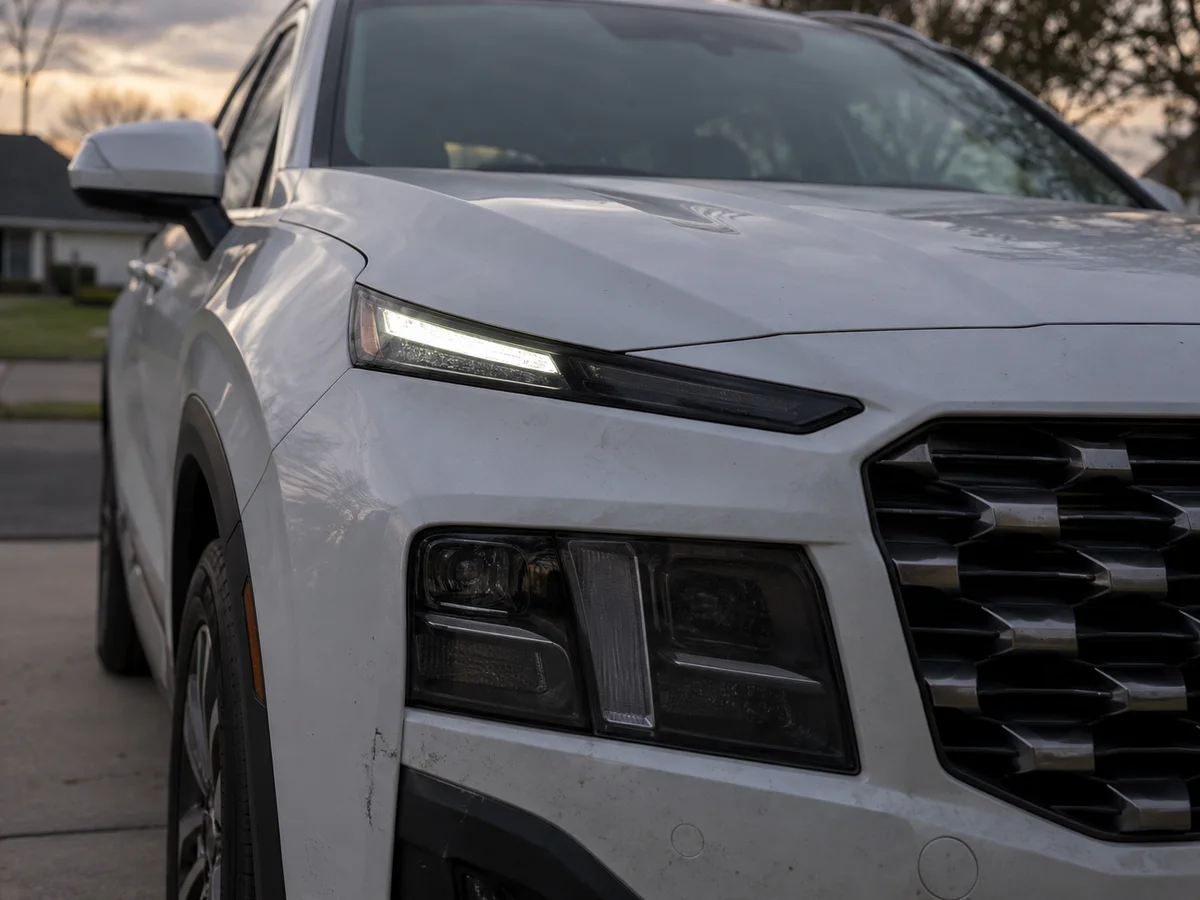 LED headlight of a Hyundai SUV at dusk with part of the light strip dark