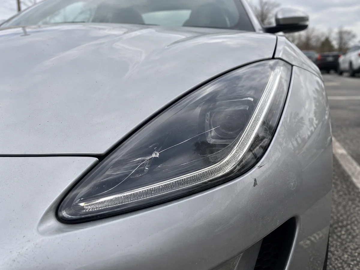 Crack running across the outer lens of a Jaguar F-Type headlight
