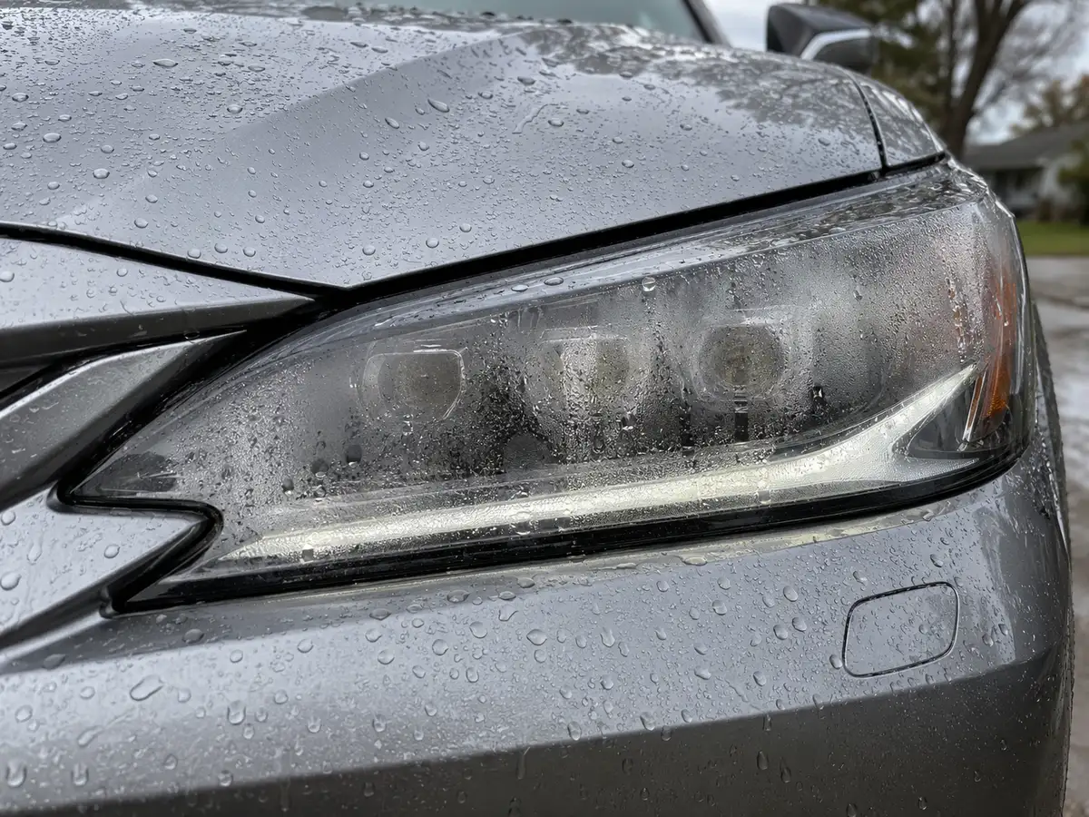 Lexus ES 350 headlight with heavy condensation on the inside of the lens after a car wash