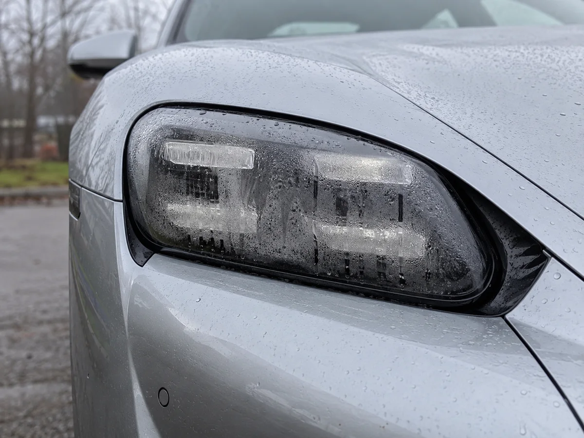Taycan LED headlight with heavy condensation across the inside of the lens