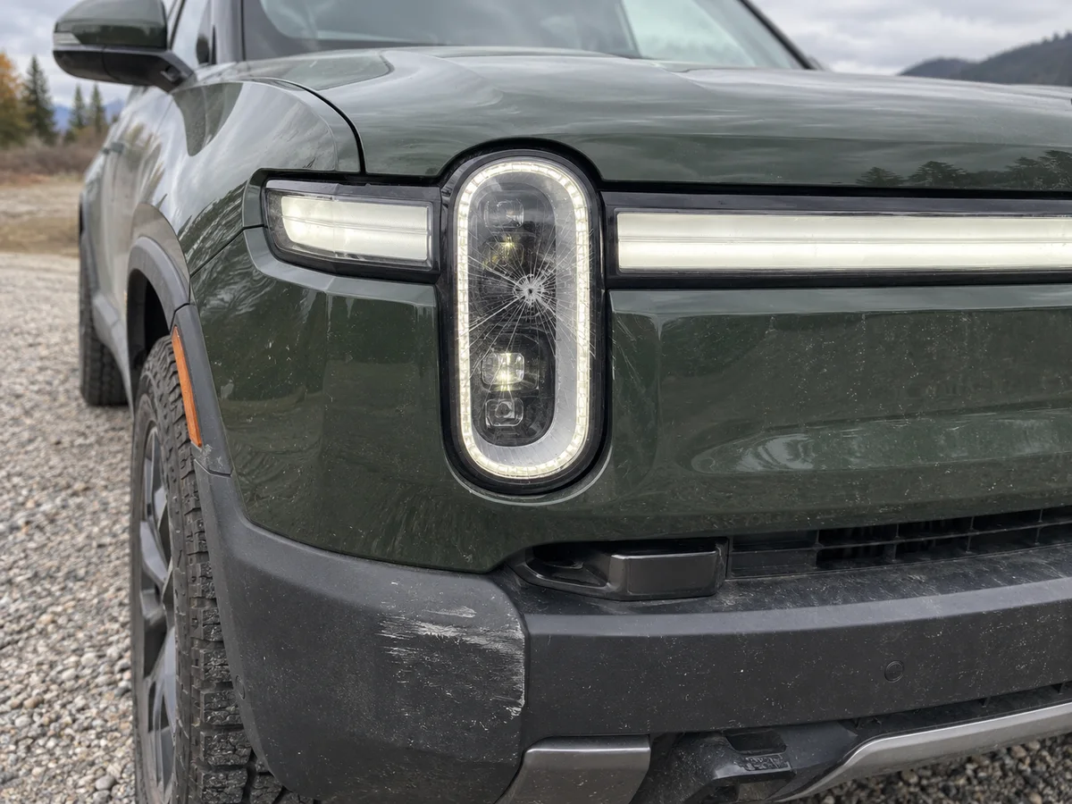 Cracked outer lens on the headlight of a Rivian R1T after a minor collision